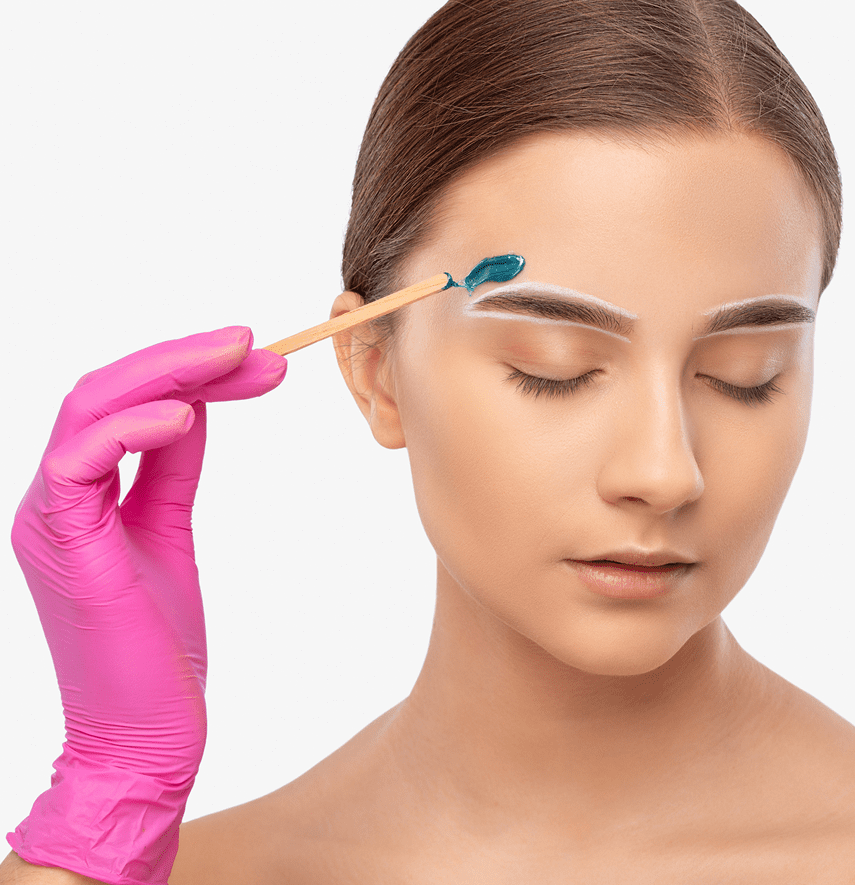 Applying wax to woman's eyebrow