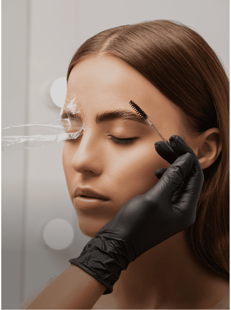 Gloved hand applying eyebrow tint